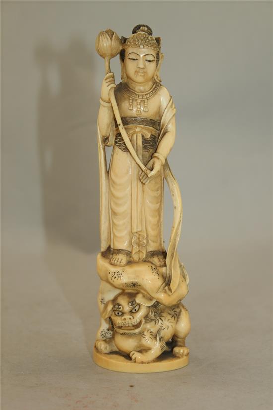 A Japanese ivory group of an immortal and a shi-shi, early 20th century, 18cm